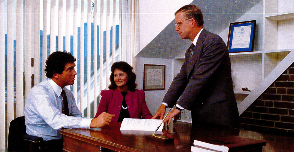 Fred Pryor explaining financial plan prototype to Steve O'Neill and Mary Zelek at the Union Wharf Office, ca. 1985.